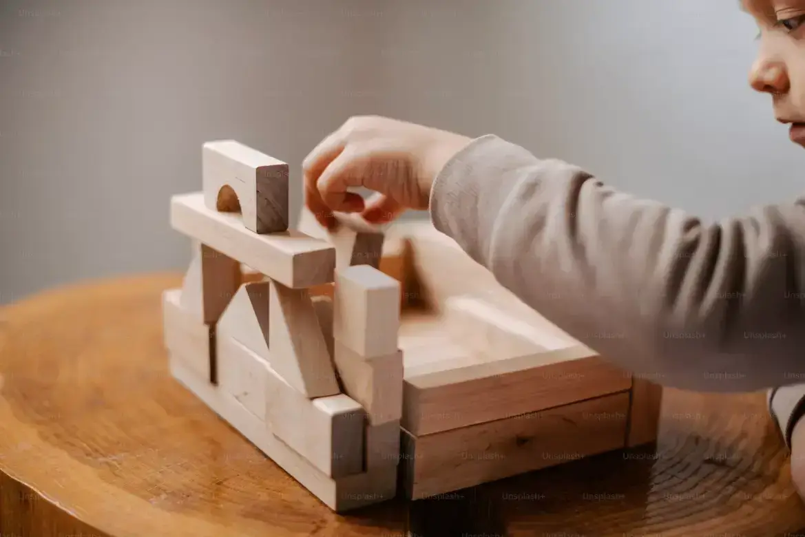 Colorful handcrafted wood art pieces made by students — animals, spoons, stars and frames